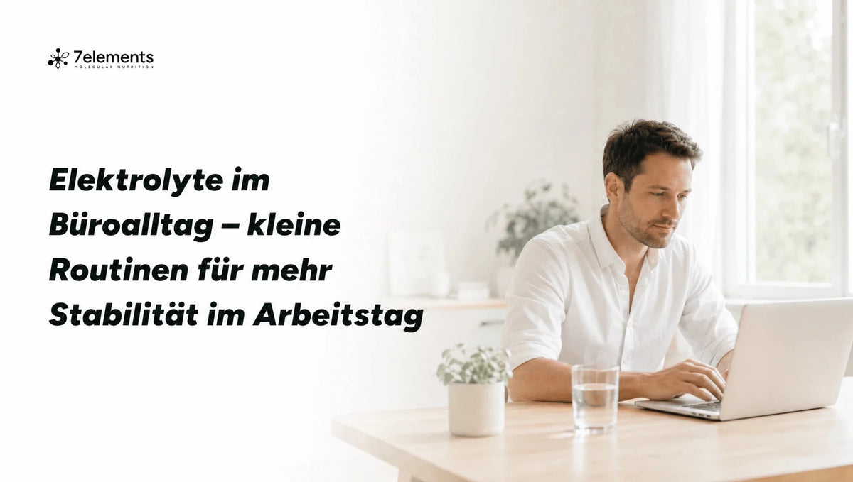 Mann arbeitet am Schreibtisch mit einem Glas Wasser – Elektrolyte im Büroalltag