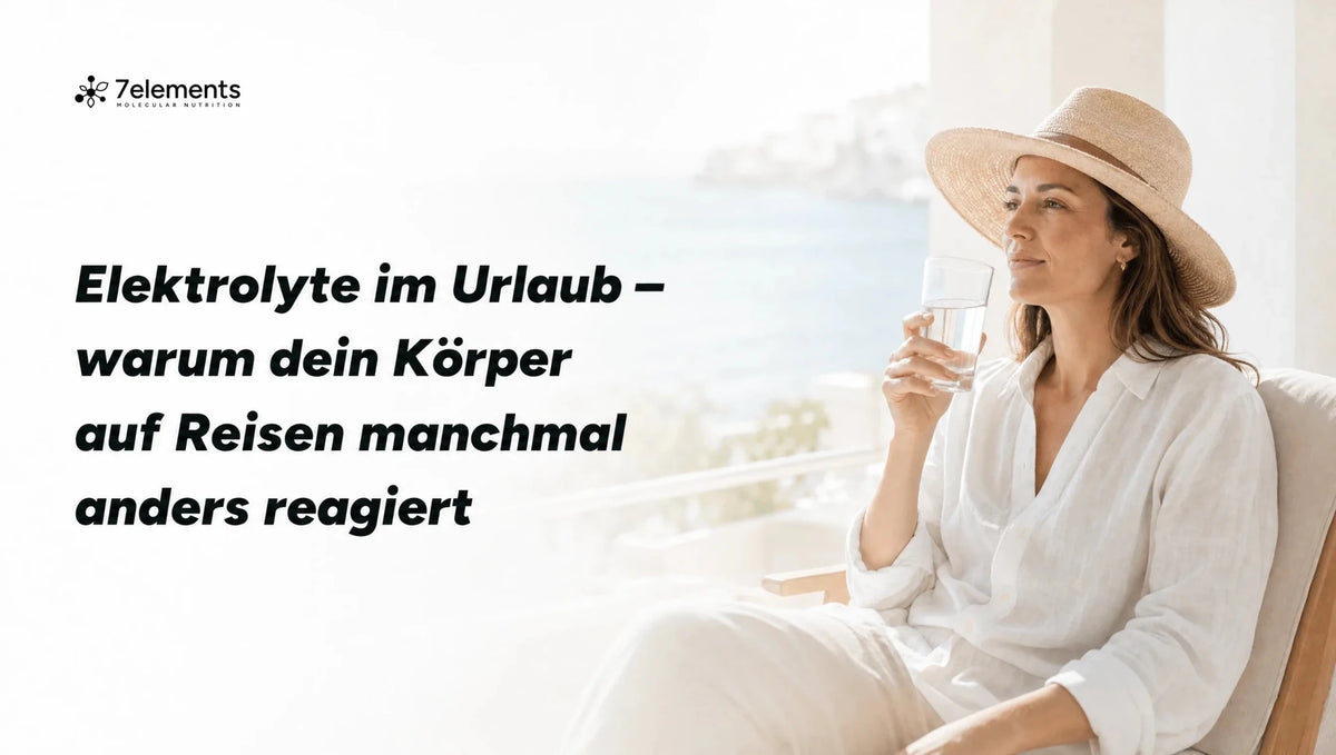 Frau mit Sonnenhut am Strand mit einem Glas Wasser – Elektrolyte im Urlaub